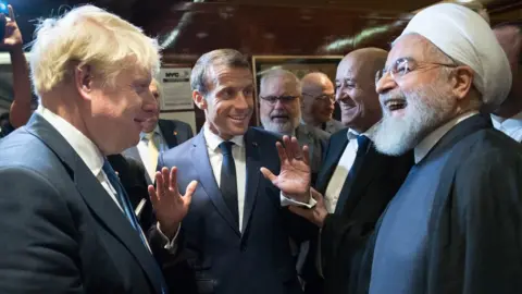 PA Media British Prime Minister Boris Johnson (left), French President Emmanuel Macron (centre) and Iran's President Hassan Rouhani (right) discuss at the UN General Assembly in New York on 24 September 2019.