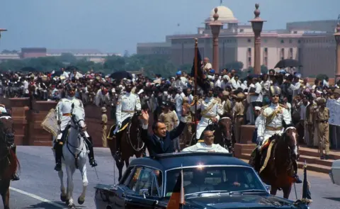 Getty Images President Richard Nixon waves to crowds as he rides in open car with the acting president of India, Mohammad Hidyatullah, in motorcade from airport upon arrival here July 31.