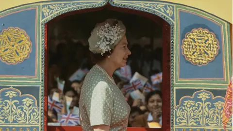 Getty Images British Royal Queen Elizabeth II wearing a pale green dress with white polka dots, and a matching pale green hat, at the Raj Ghat Mahatma Gandhi Memorial in Delhi during a nine-day State Visit to India, 17th November 1983. (Photo by Tim Graham Photo Library via Getty Images)
