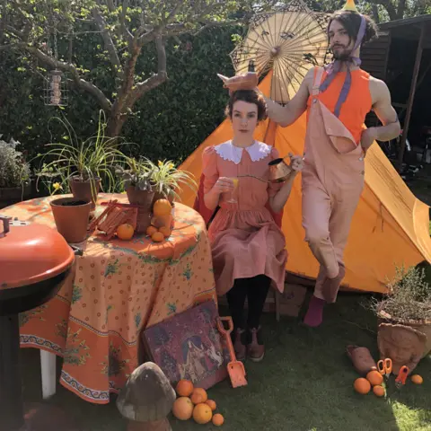Helen Yang Helen Yang and Thomas Etheridge in orange outfits