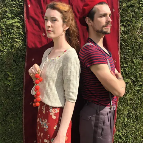Helen Yang Helen Yang and Thomas Etheridge in red outfits